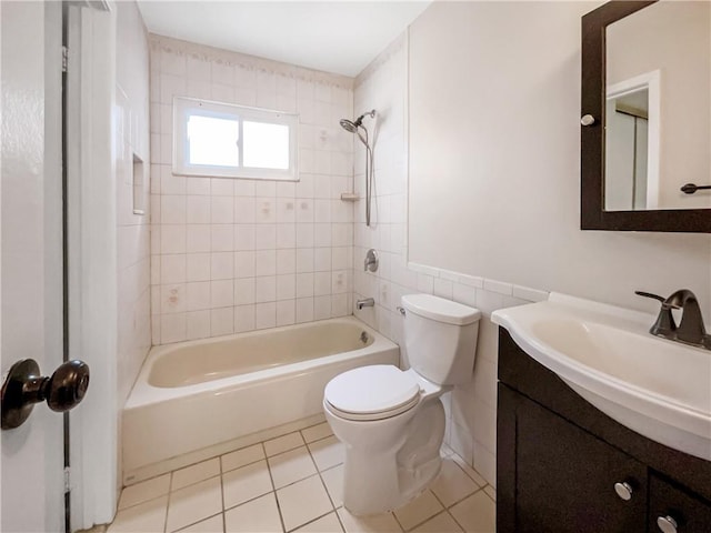 full bathroom with toilet, vanity, tile patterned floors, and tiled shower / bath