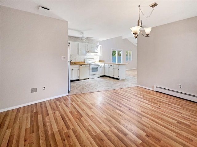 interior space with a baseboard heating unit, ceiling fan with notable chandelier, light hardwood / wood-style flooring, and lofted ceiling