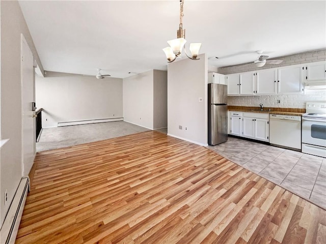 kitchen featuring white cabinetry, white appliances, light hardwood / wood-style flooring, and a baseboard radiator