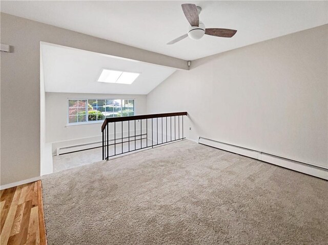 bonus room with ceiling fan, wood-type flooring, lofted ceiling with beams, and a baseboard heating unit