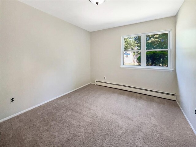 carpeted spare room with baseboard heating