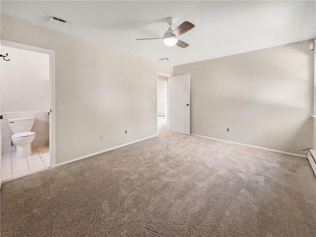 unfurnished bedroom featuring carpet flooring, ensuite bath, and ceiling fan