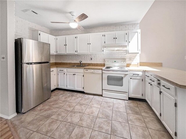 kitchen featuring ceiling fan, sink, white cabinets, and white appliances