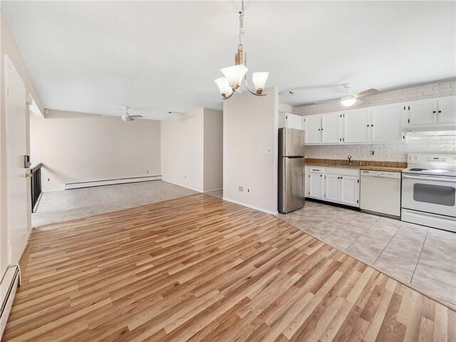 kitchen with baseboard heating, white cabinets, white appliances, and light wood-type flooring