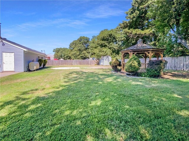 view of yard with a gazebo and a storage shed