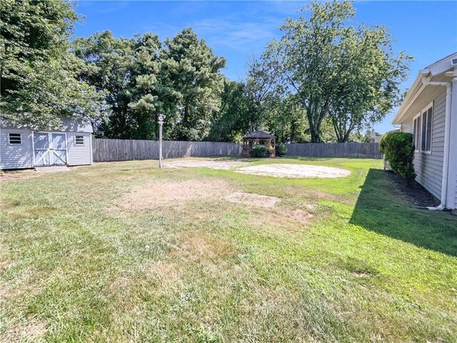 view of yard with a gazebo and a storage unit
