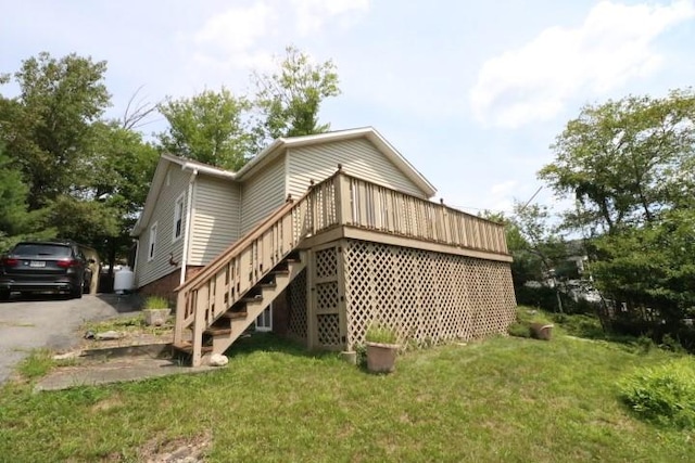 view of property exterior featuring a yard and a wooden deck