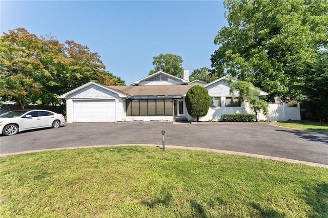 single story home with a front yard, driveway, an attached garage, and fence