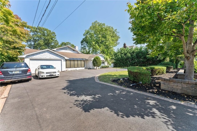 view of front facade featuring aphalt driveway and a garage