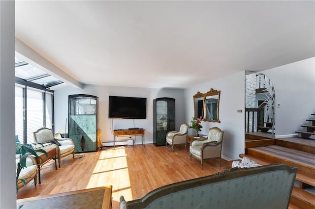 living room featuring lofted ceiling with beams, wood finished floors, baseboards, stairs, and baseboard heating