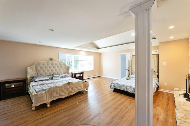 bedroom featuring recessed lighting, baseboards, baseboard heating, and wood finished floors