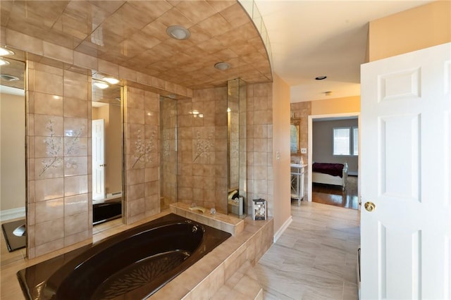 full bath featuring a tile shower, baseboards, and a bath