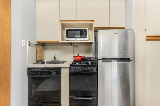 3935 Blackstone Ave Unit 4K, Bronx, NY 10471 - kitchen with white cabinets, sink, and black appliances