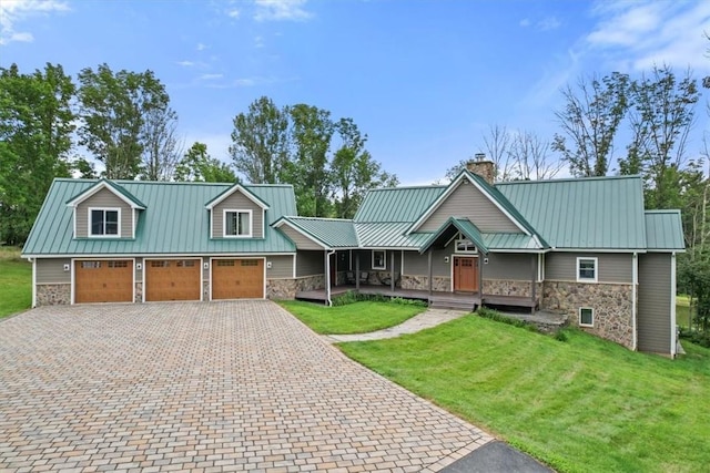 view of front of home with a front lawn, covered porch, and stone siding
