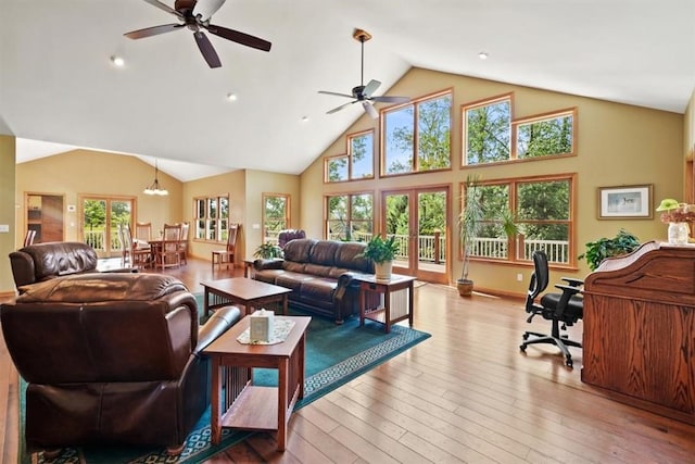 living room with high vaulted ceiling, a ceiling fan, and wood-type flooring