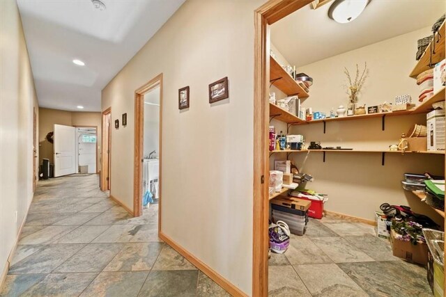corridor with baseboards and recessed lighting