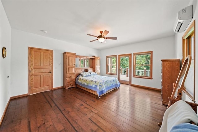 bedroom with a wall mounted air conditioner, baseboards, access to outside, and dark wood finished floors