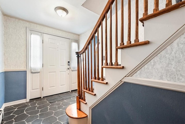 entrance foyer featuring ornamental molding