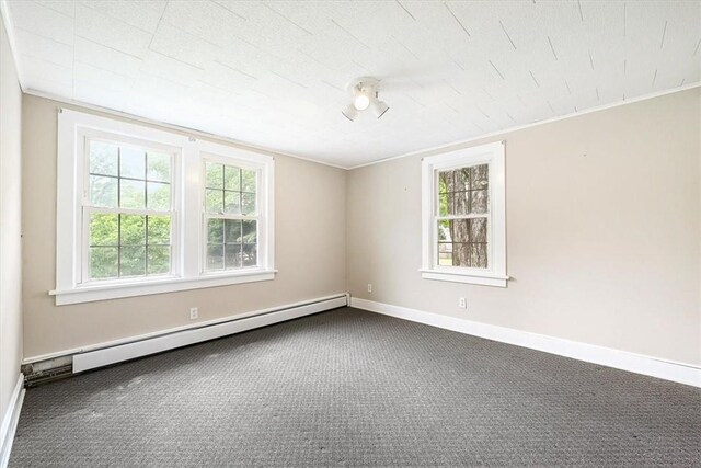 spare room with baseboard heating, carpet, and ornamental molding