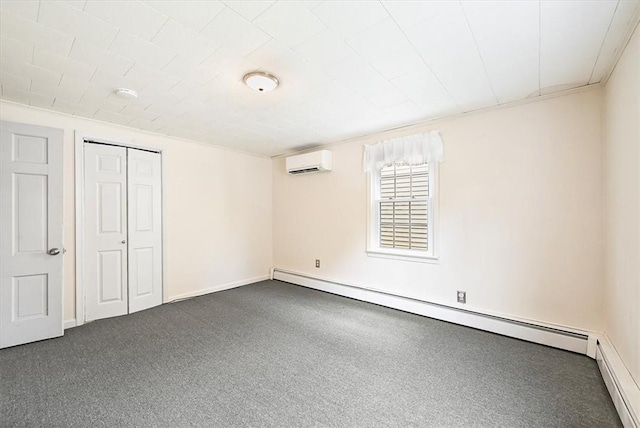 unfurnished bedroom with baseboard heating, a wall mounted AC, a closet, and dark colored carpet