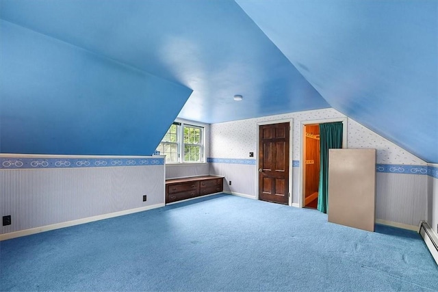 additional living space with carpet flooring, lofted ceiling, and a baseboard heating unit