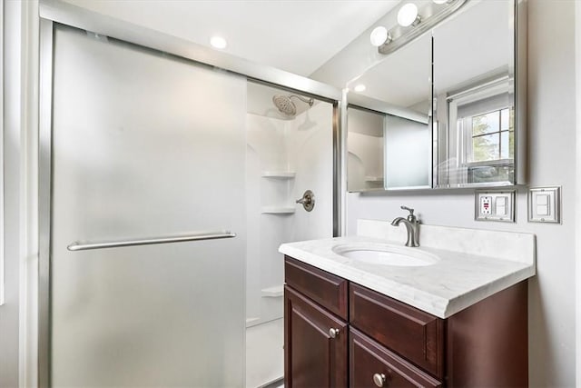 bathroom with vanity and a shower with shower door