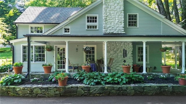 back of house featuring covered porch