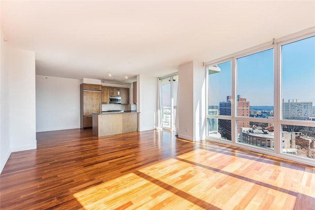 unfurnished living room featuring hardwood / wood-style floors