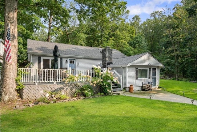 rear view of house featuring a yard