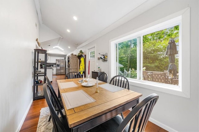 dining room featuring vaulted ceiling and hardwood / wood-style flooring