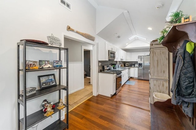 kitchen featuring white cabinetry, sink, stainless steel appliances, and dark hardwood / wood-style floors