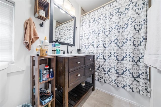 bathroom with tile patterned flooring, vanity, and shower / bathtub combination with curtain