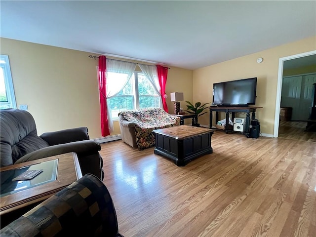 living room featuring light hardwood / wood-style flooring and a baseboard heating unit