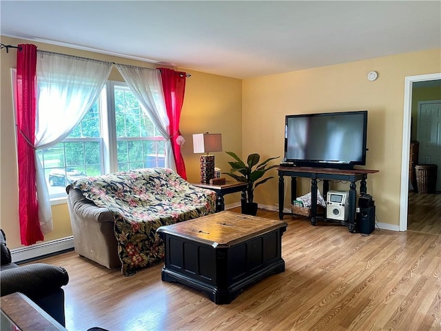 living room with light wood-type flooring and a baseboard radiator