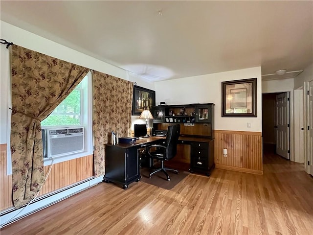 home office featuring wood walls, light hardwood / wood-style flooring, cooling unit, and a baseboard heating unit