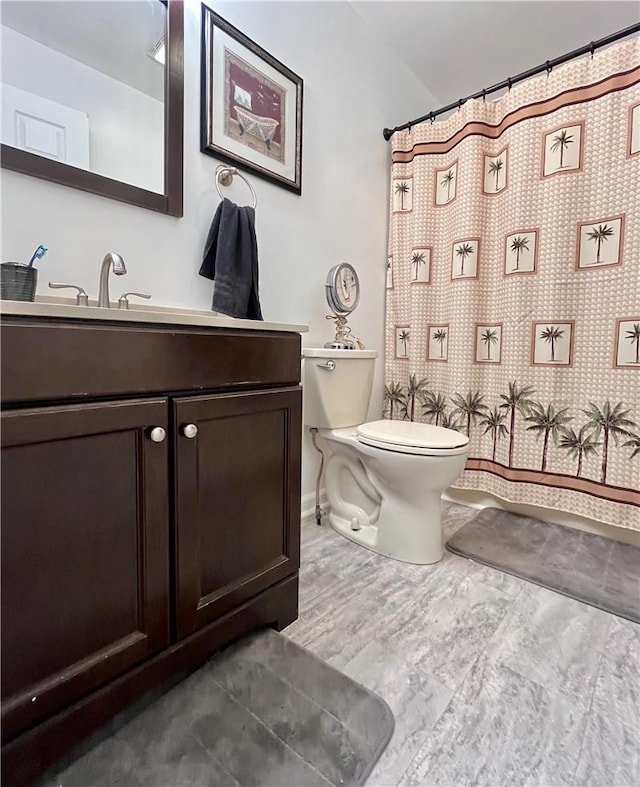 bathroom featuring hardwood / wood-style floors, vanity, and toilet