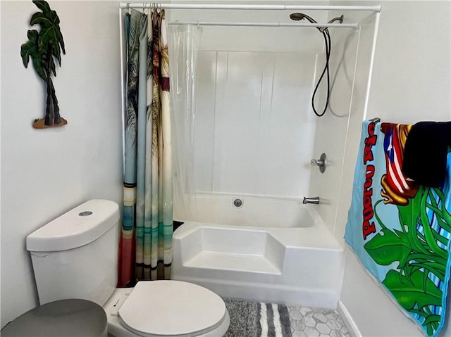 bathroom featuring tile patterned flooring, toilet, and shower / bath combo with shower curtain