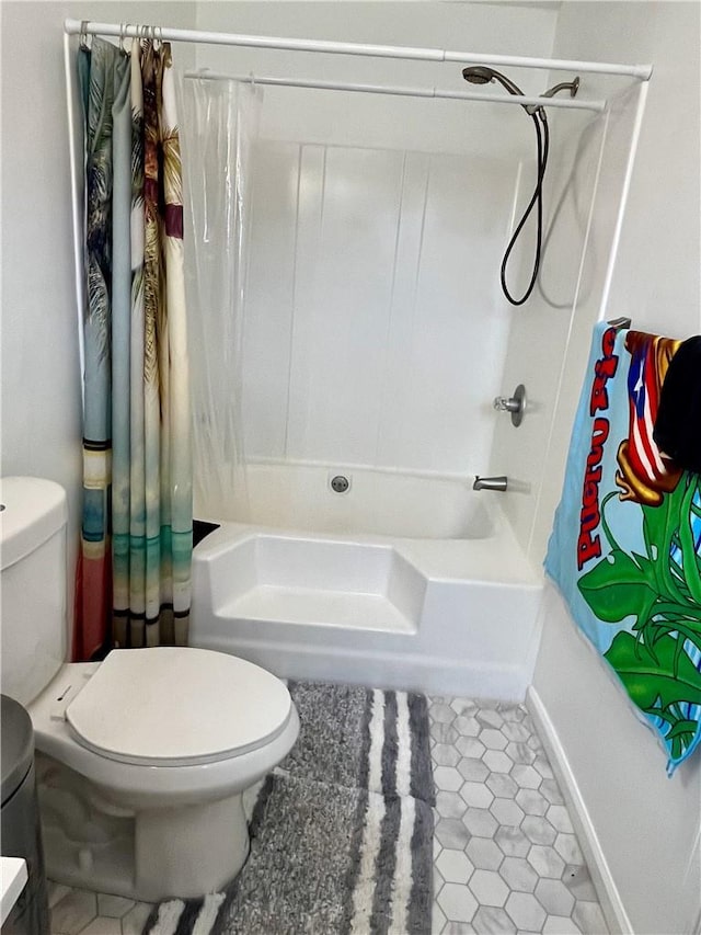 bathroom with tile patterned flooring, toilet, and shower / tub combo