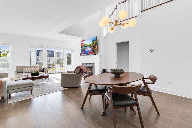 dining room featuring dark wood-type flooring and a healthy amount of sunlight