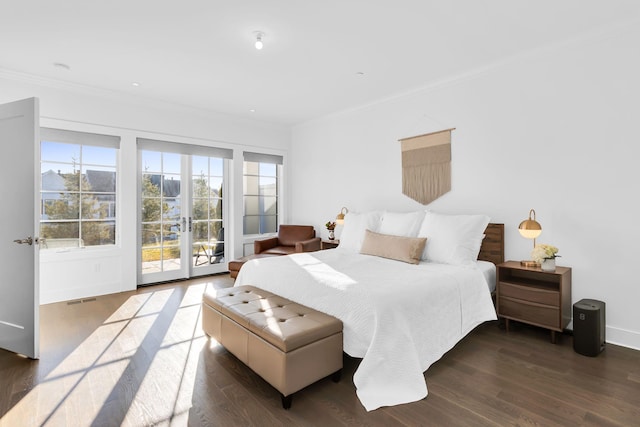 bedroom with dark hardwood / wood-style flooring, access to exterior, ornamental molding, and french doors