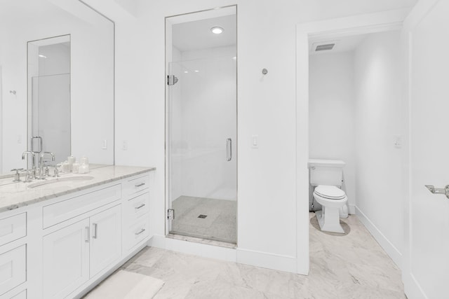 bathroom with a shower with door, vanity, and toilet