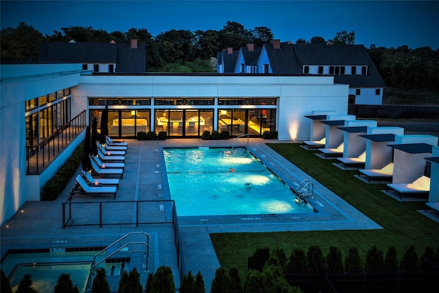 view of pool with a patio and a yard