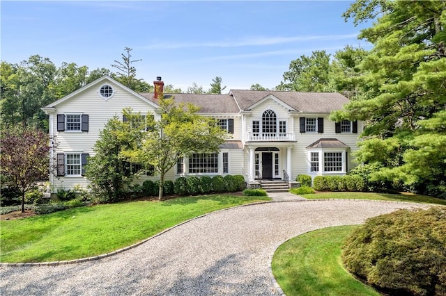 colonial-style house with a front yard