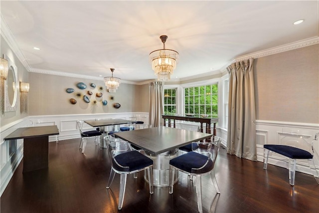 dining area featuring crown molding, dark wood-type flooring, and an inviting chandelier