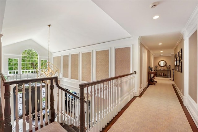 hall featuring lofted ceiling and crown molding