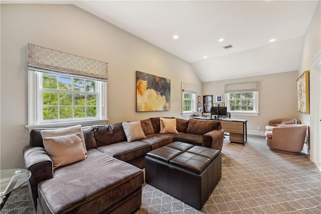 living room featuring vaulted ceiling, a wealth of natural light, and light carpet