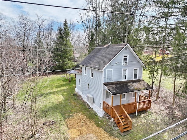 view of property exterior with a deck and a yard