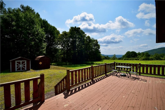 wooden deck featuring a yard and a storage shed