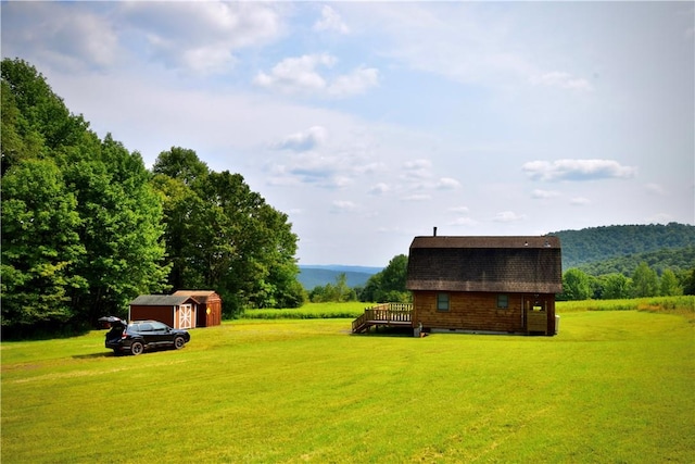 view of yard with a shed and a wooden deck