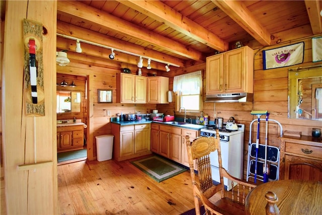 kitchen featuring wooden walls, light hardwood / wood-style floors, white range oven, and light brown cabinetry